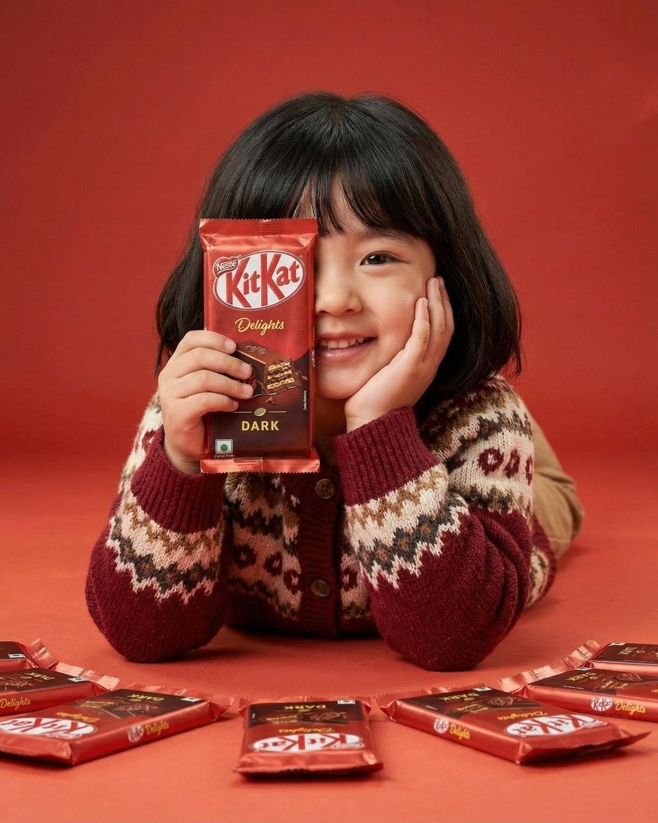 A cute young girl with short black hair and bangs smiling...