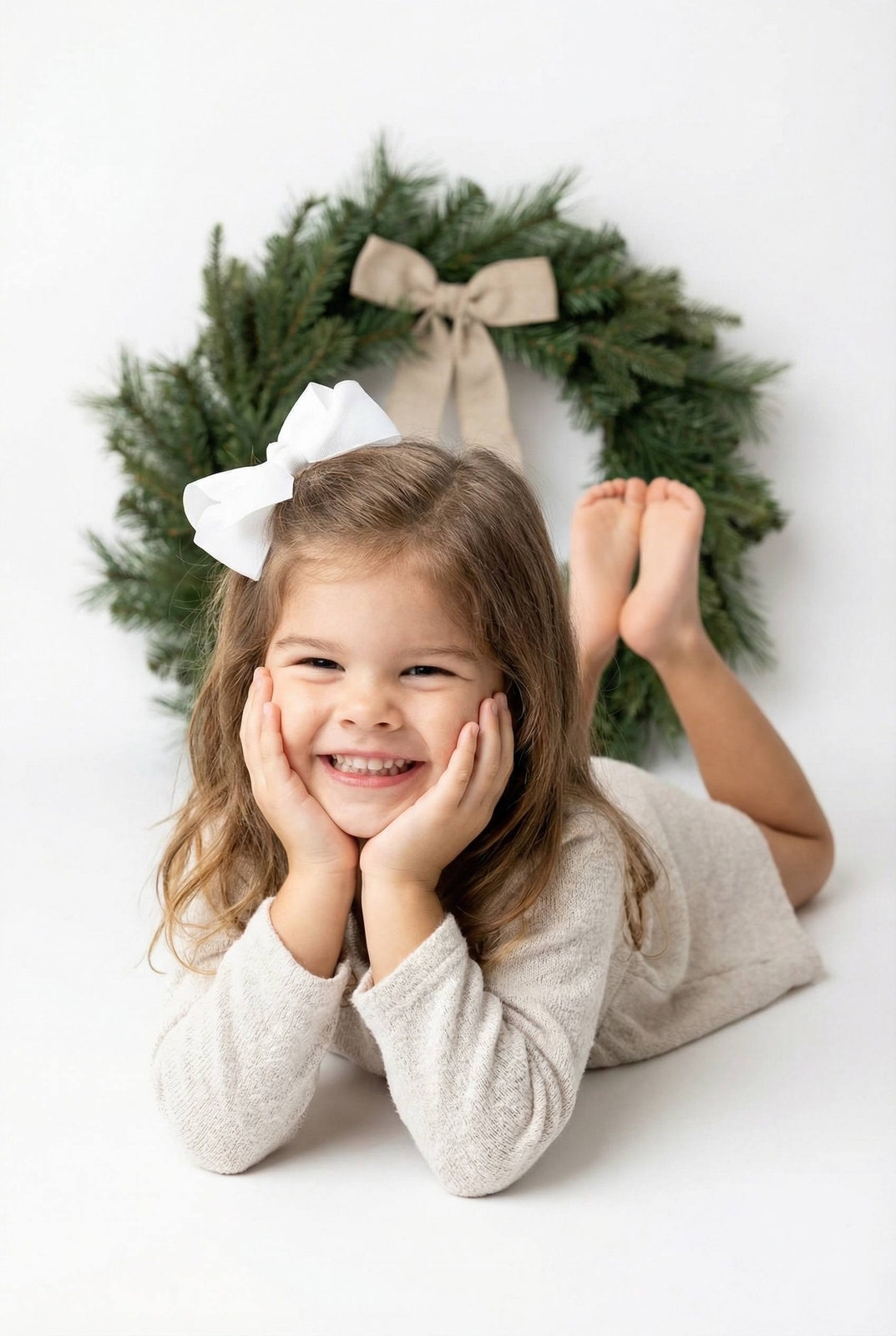 Joyful Girl with Christmas Wreath Portrait