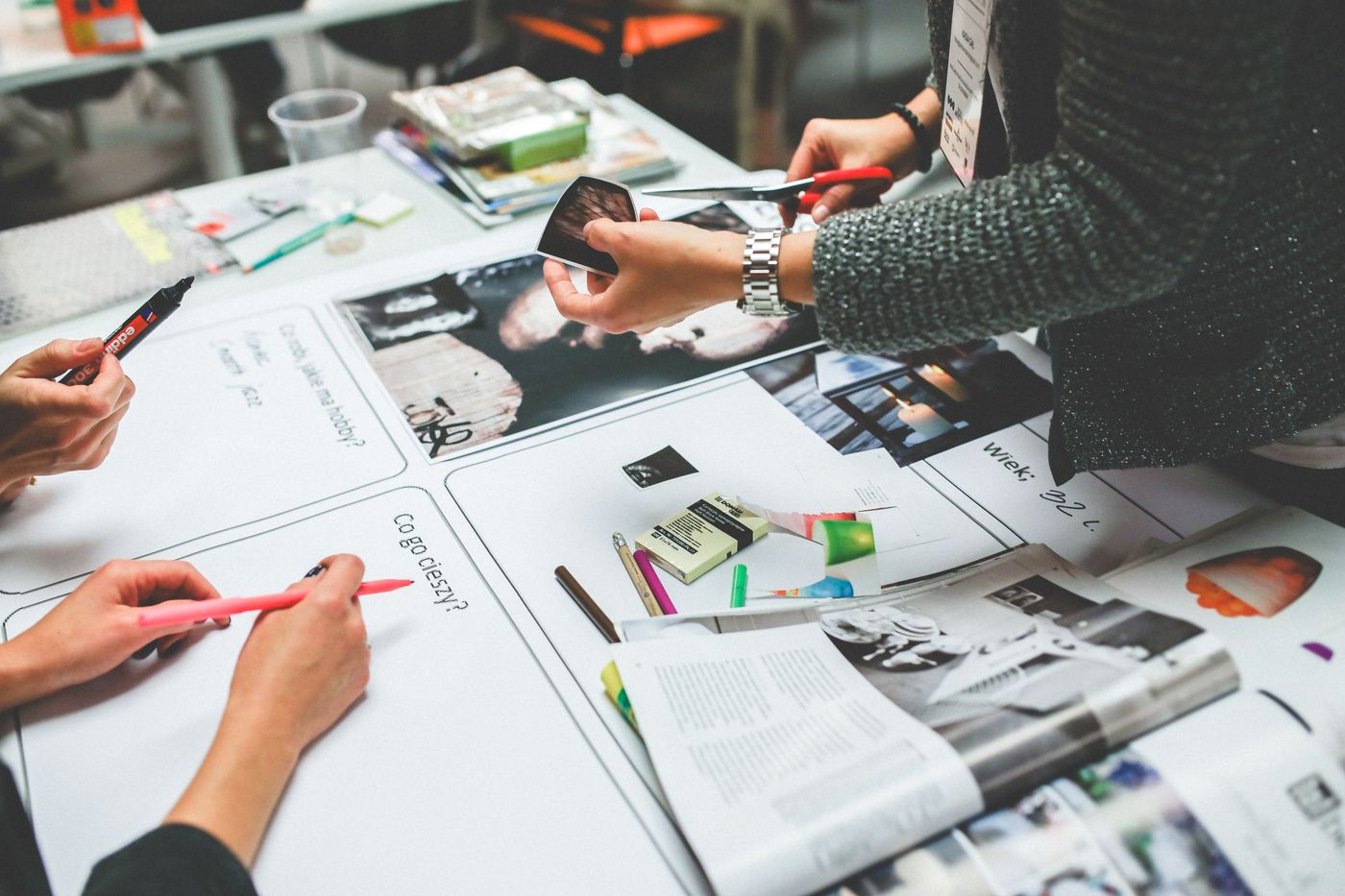 Creative team reviewing brand assets at desk — consistency audit