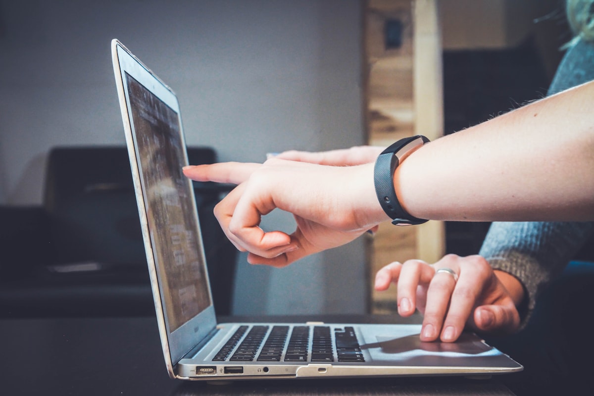 Laptop with handwritten notes representing concise creative brief template