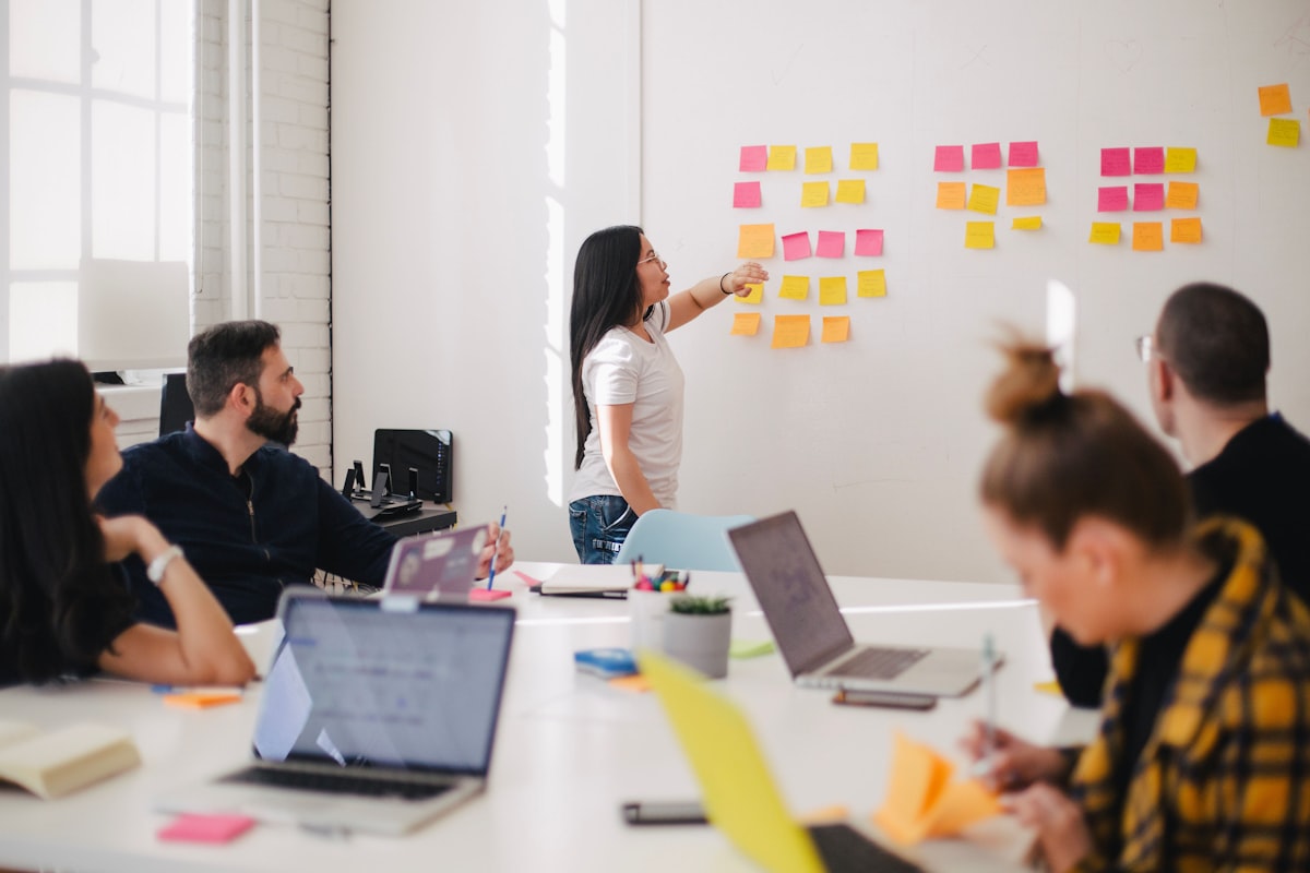 Creative team reviewing brief documents in meeting room