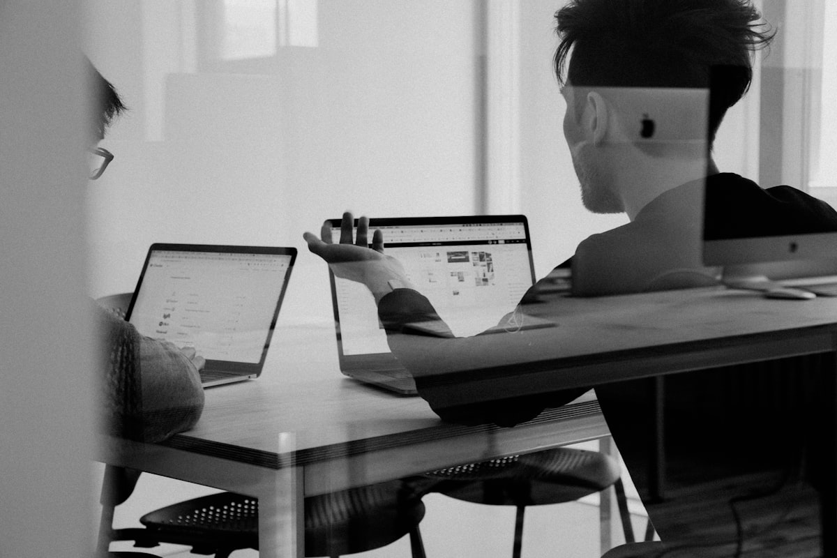 Organized creative workspace with multiple monitors for freelance design workflow